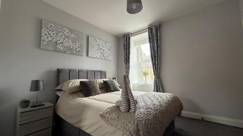 a bedroom with a bed with a large window at The Bakehouse - by Caithness Luxury Apartments NC500 - 5 Bedroom Luxury Holiday Home - Sleeps Work teams upto 5 & holiday makers upto 10 in Wick