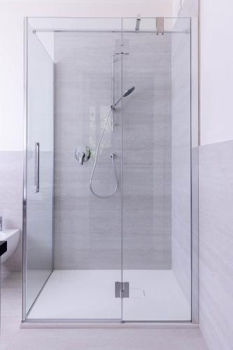 a shower with a glass door in a bathroom at Il cubo di Aligi in Missaglia