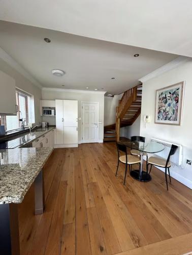 a kitchen with a table and a dining room at Crawford House- ScholarLee Living Apartments in Cork