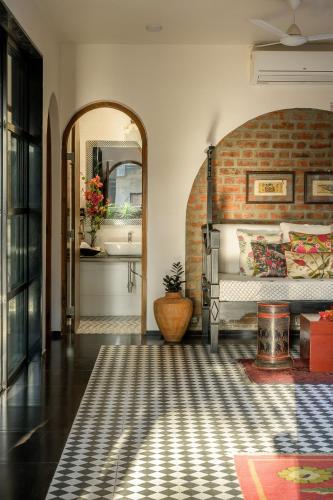 a room with a bed and a mirror and a sink at SaffronStays Jade in Kārli