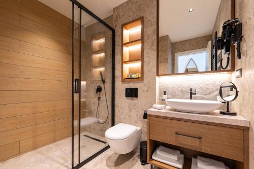 a bathroom with a sink and a toilet and a shower at Hotel Palazzo del Mare - Essenza in Kotor