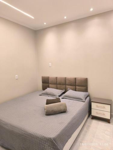 a bedroom with a bed with a pillow on it at Apto Lindo e Aconchegante 3 in Manaus