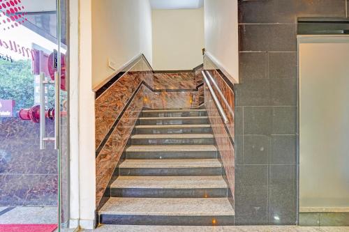 a staircase in a building with a glass door at FabHotel Millennials in Bengaluru