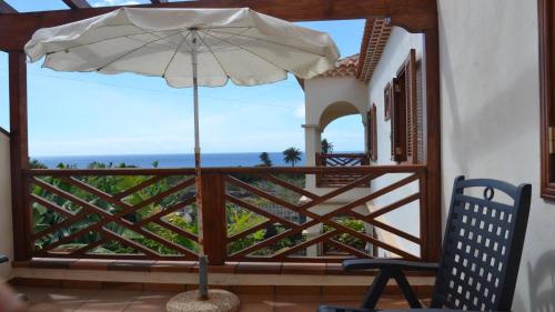 a patio with an umbrella and a chair at Apt. Heliconia Nº 6 in Valle Gran Rey