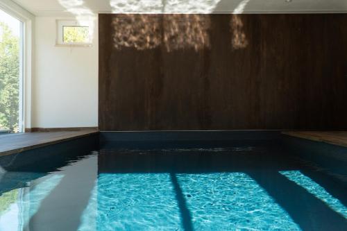 a swimming pool with blue water in a room at Quinta do Areal in Lousã