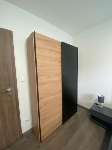 a wooden door in a room next to a wall at Apartmán pod Pálavskými vrchy in Pavlov