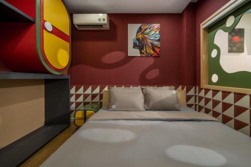 a room with a bed and a painting on the wall at Q Apartment Da Nang in Da Nang