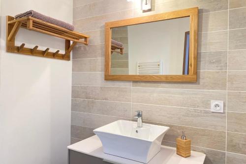 a bathroom with a white sink and a mirror at Villa Californie - Domaine Le Sherwood in Notre-Dame-de-Monts