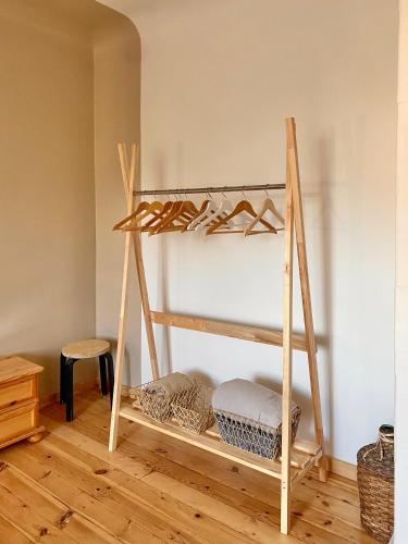 a wooden shelf with shoes on it in a room at KULDIGA CENTRE wooden apartment in Kuldīga
