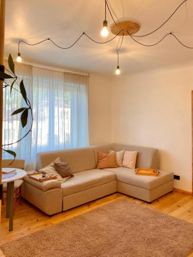 a living room with a couch and a table at KULDIGA CENTRE wooden apartment in Kuldīga