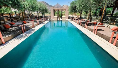 a swimming pool at a resort with blue water at Ikaros Suites in Amoudara Herakliou