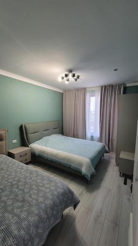a bedroom with two beds and a window at Two Yurts in Cholpon-Ata