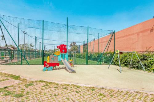 a playground with a slide in a park at Noria Isli Dar Noor in Marrakech