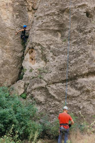 two people climbing on a rock wall with a rope at Sareni in Areni