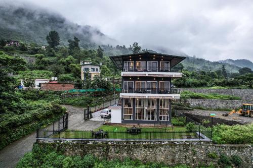 a house on a hill with a fence around it at Celeste Vista by Chirping Hills in Bhīm Tāl