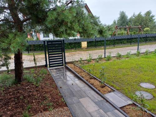 a park with a tree and a playground at Willa Przygoda in Żukowo