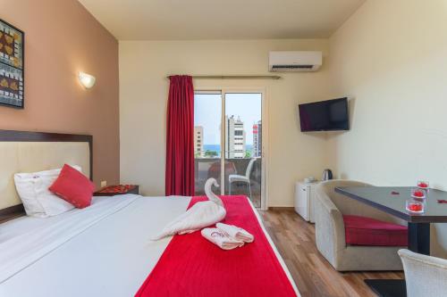 a hotel room with a bed with a swan on a red rug at Al Murjan Palace Hotel Jounieh in Jounieh