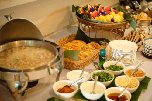 a buffet with bowls of food on a table at Delio Boutique Hotel in Udon Thani