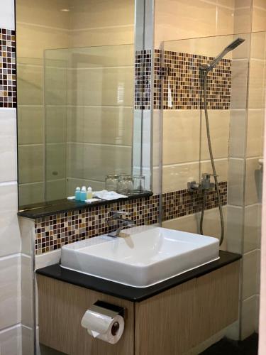 a bathroom with a sink and a shower at Delio Boutique Hotel in Udon Thani