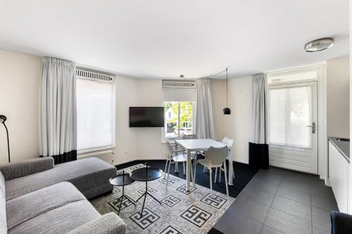a living room with a couch and a table at B's Strandappartementen in Domburg