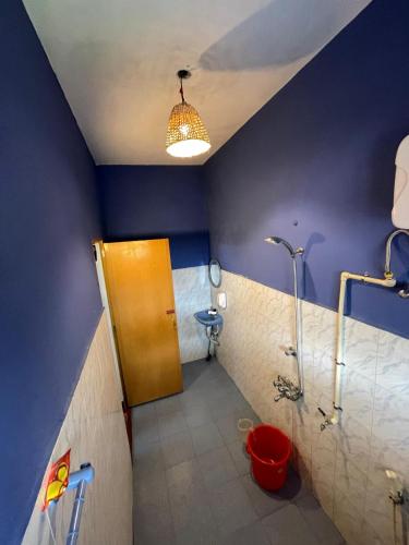 a bathroom with a shower and a toilet in a room at HostelExp, Varkala - A Beach Town Hostel in Varkala