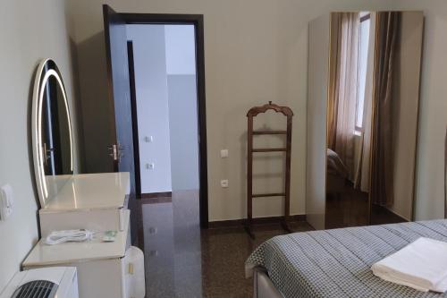 a bedroom with a bed and a mirror and a ladder at 4 Bed Villa-Sleeps 8-Parking-Garden-Sea View in Ureki