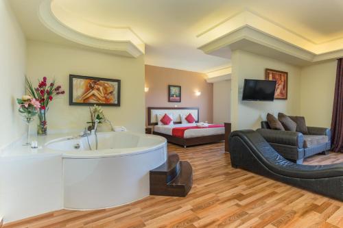 a large living room with a tub and a couch at Al Murjan Palace Hotel Jounieh in Jounieh