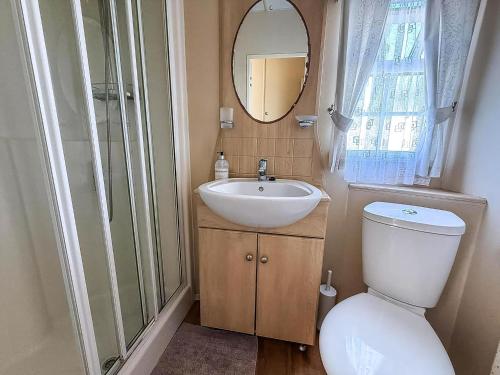 a bathroom with a toilet and a sink and a mirror at Great 6 Berth Caravan For Hire At Cherry Tree Holiday Park In Norfolk Ref 70801C in Great Yarmouth