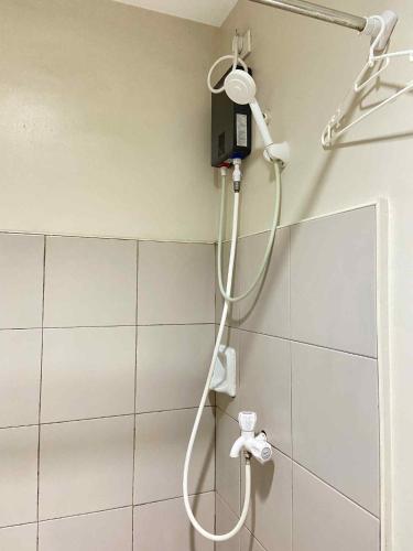 a shower in a bathroom with a shower head at Sunvida Tower Across SM City Cebu in Cebu City