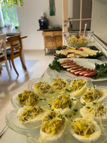 a buffet with several plates of food on a table at Zakątek Słoneczny pod Baranią Górą in Kamesznica