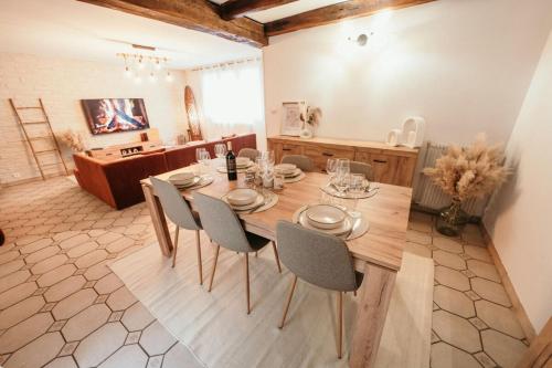 a dining room with a wooden table and chairs at The Champenoise Jacuzzi - Vineyard in Verzenay
