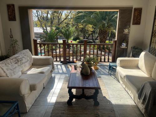 a living room with two couches and a coffee table at Follyfoot Manor in Midrand