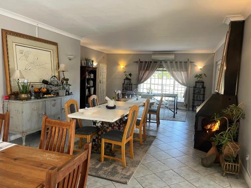 a kitchen and dining room with a table and chairs at Follyfoot Manor in Midrand