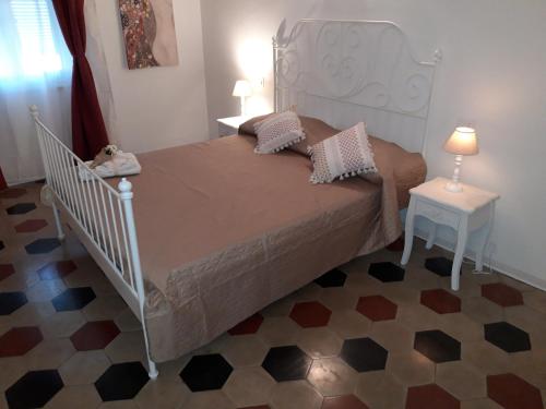 a bedroom with a large bed and a table with a lamp at Casa Marina in La Spezia