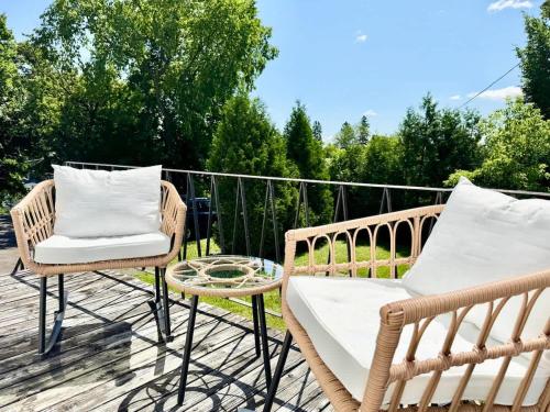 a patio with two chairs and a table on a deck at The Royal d'Antan 8 people Parking in Quebec City