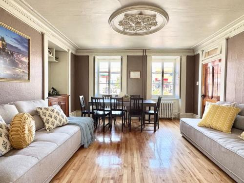 a living room with a couch and a dining room at The Royal d'Antan 8 people Parking in Quebec City