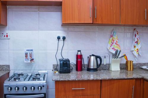 a kitchen counter with a stove and a blender at KAREN Comfort 3BR Holiday Home Nandi Rd off Miotoni in Nairobi