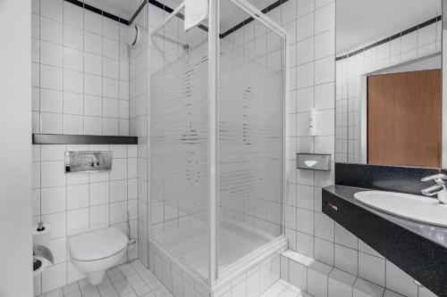 a bathroom with a shower and a toilet and a sink at Express Kraków Hotel in Kraków
