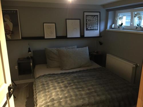 a bedroom with a bed and a window at Home Apartman in Nagyesztergár