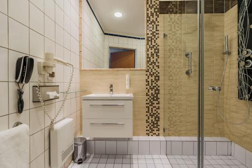 a bathroom with a shower and a sink at Express Kraków Hotel in Kraków