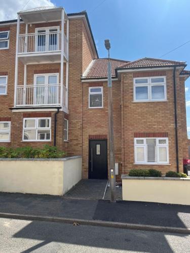 a brick apartment building with a black door at Seaview House with Sea View Brand New- 3 Bedrooms - Harwich, Dovercourt in Lancing