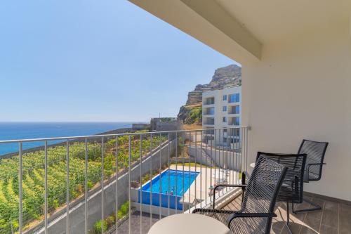 a balcony with a view of the ocean at Pearl Retreat by Holiday Rental Madeira in Câmara de Lobos
