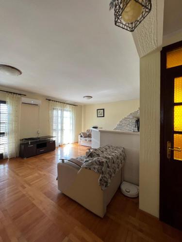 a living room with a couch and a bed in it at Villa Maša in Zelenika