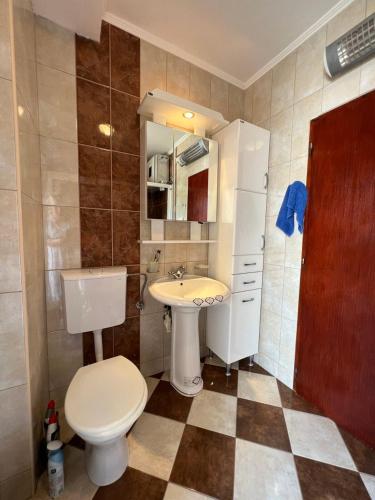 a small bathroom with a toilet and a sink at Villa Maša in Zelenika