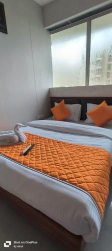 a large bed with orange pillows on a boat at Hotel Cloud 7 in Ahmedabad