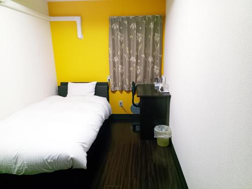 a small room with two beds and a window at Ace Inn Asakusa in Tokyo