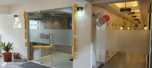 a glass door in a room with a hallway at Hotel Cloud 7 in Ahmedabad