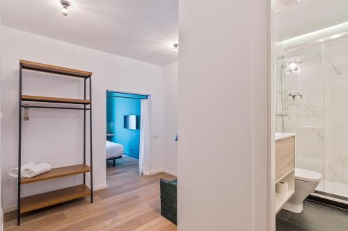 a bathroom with a sink and a toilet in a room at Uma Suites Atocha in Madrid