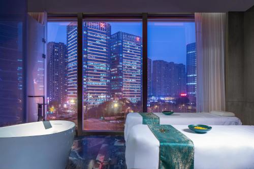 a bathroom with a view of a city skyline at W Chengdu in Chengdu