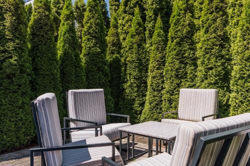 a patio with two chairs and a table in front of a wall at Express Kraków Hotel in Kraków